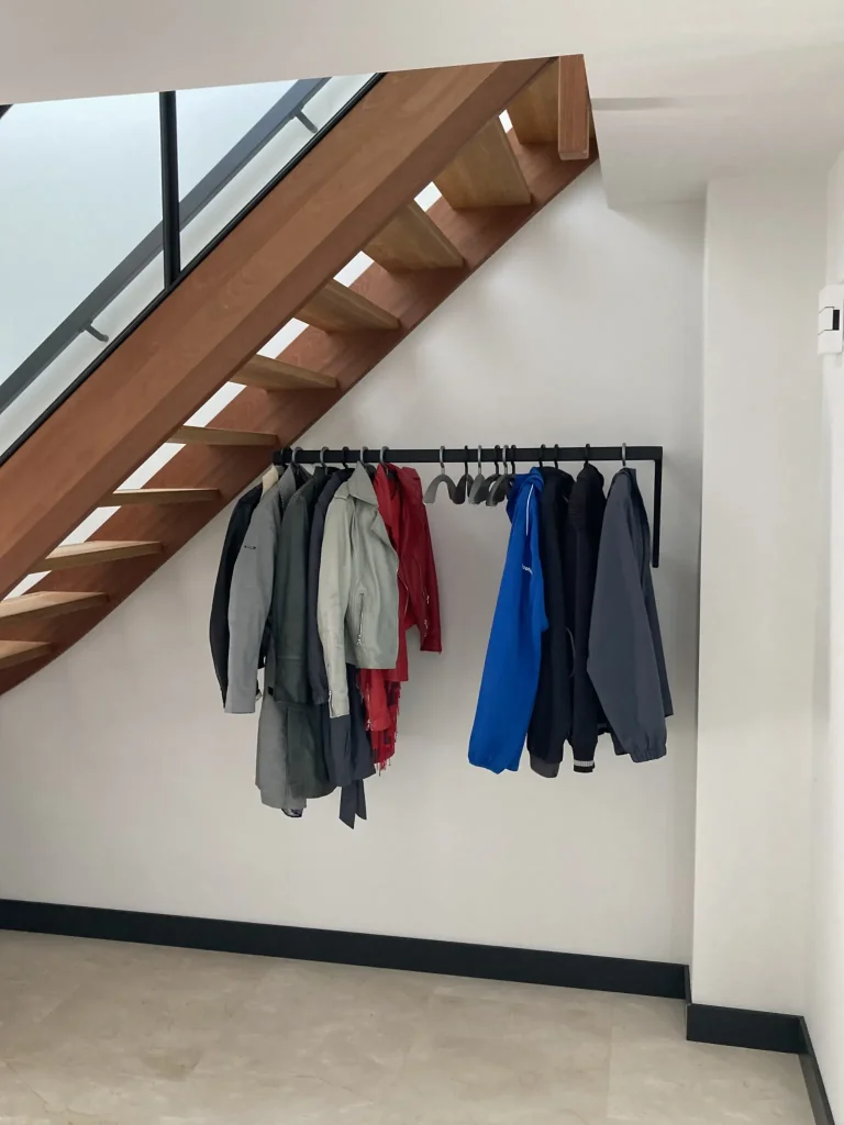 Zwarte design kapstok onder de trap